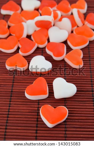 Heart shaped fruit candy on bamboo background
