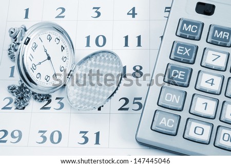 Business concept, calculator and watch on calendar