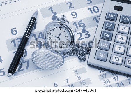 Business concept, calculator, pen and watch on calendar
