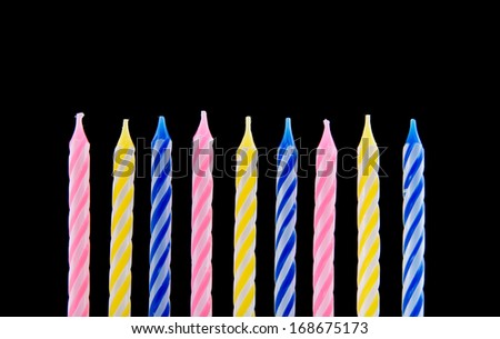 Colored candles on black background