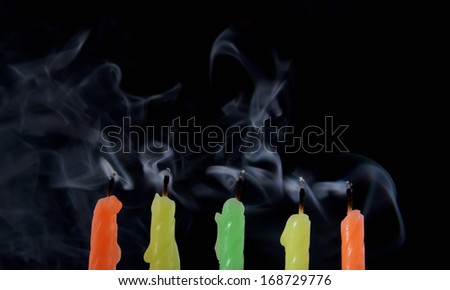 Candles with smoke on black