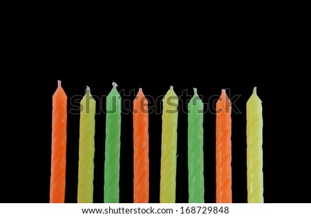 Colored candles on black background