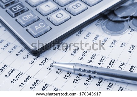 Business concept with pen, calculator and coins