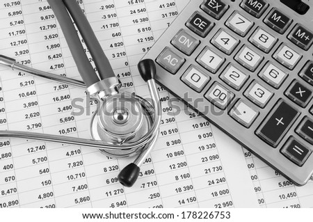 Cost of health care concept, stethoscope and calculator on document