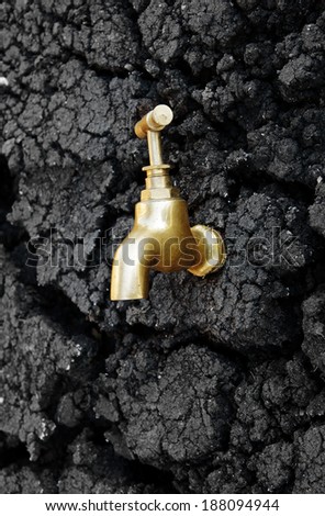 Water source concept, faucet on dry soil texture