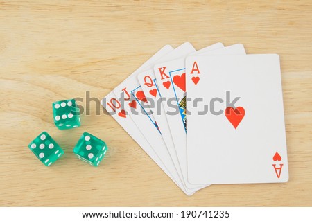 Dices and cards on wooden table