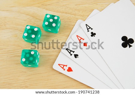 Dices and cards on wooden table
