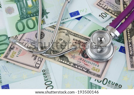 Stethoscope on euro and dollar banknotes, cost of healthcare concept