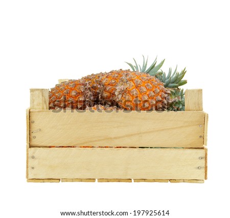 Pineapple fruits in wooden box isolated on white background