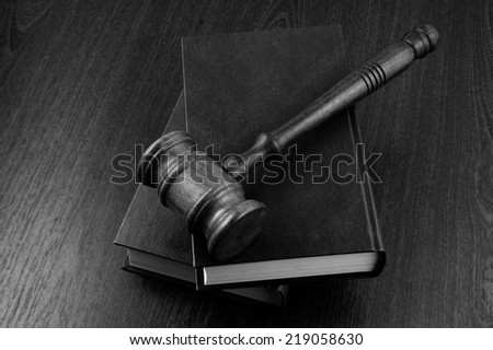 Judge\'s gavel and legal books on wooden table
