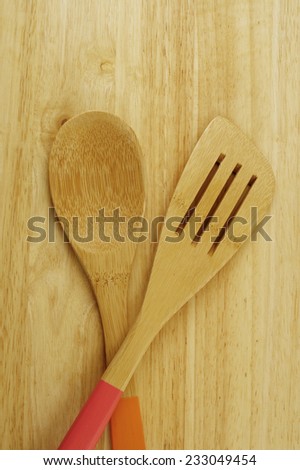 Wooden spoon and spatula on table