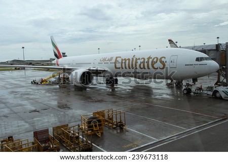 KUALA LUMPUR INTERNATIONAL AIRPORT - DECEMBER 17, 2014: Ground crew prepares Emirates Airlines plane for the next flight, December 17, 2014 in KLIA, Malaysia.