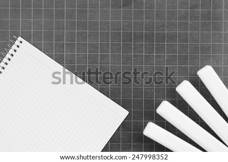 Blank school board with chalk and blank checked note paper for text