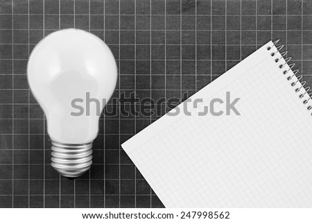 School board with lamp and blank checked note paper for text