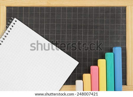 Blank school board with color chalk and blank checked note paper for text