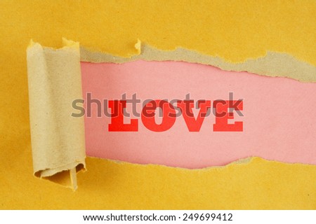 Torn yellow paper with pink background and word love