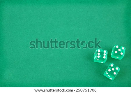 Three dices on green gaming table
