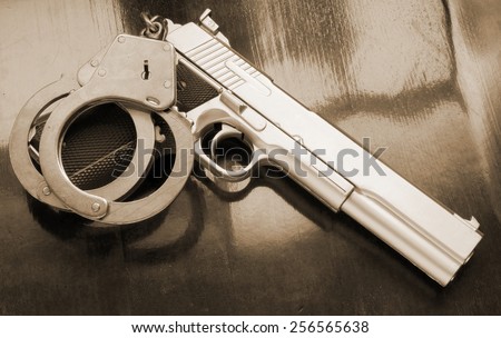 Gun and handcuffs on table