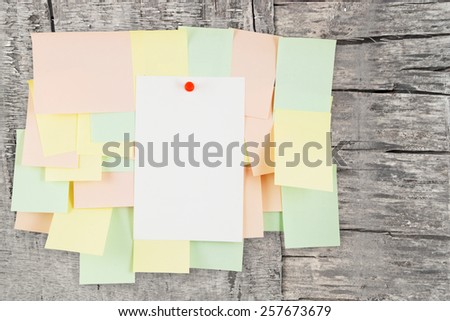 A lot of note papers on grunge wooden background