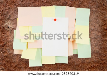 A lot of note papers on old brown wall