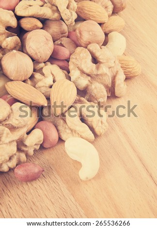 Mixed nuts on wooden background
