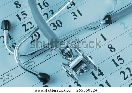 Stethoscope on calendar background, regular medical examination concept