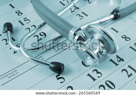 Stethoscope on calendar background, regular medical examination concept