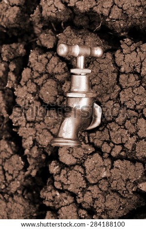 Water source concept, faucet in dry soil