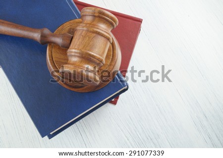 Judge\'s gavel and legal books on white table