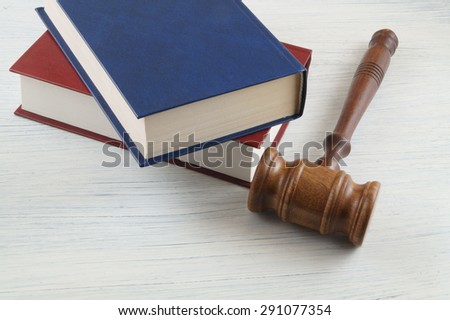 Gavel and legal books on wooden table