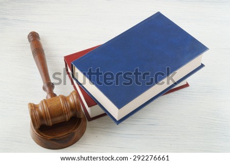 Judge\'s gavel and blue and red legal books