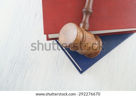 Judge\'s gavel and legal books on white table
