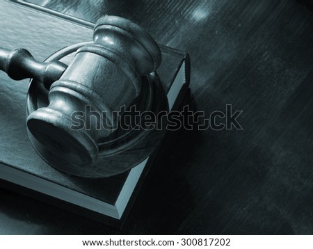 Wooden judge  gavel and legal book on wooden table