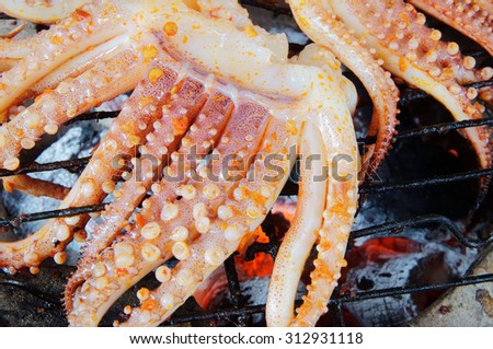 Cooking seafood barbecue, BBQ grilled squid on grid