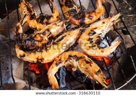 Grilled shrimps on the flaming grill, seafood barbecue