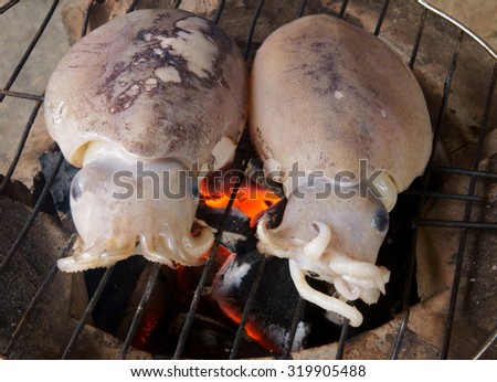 Cooking seafood barbecue, BBQ grilled squid on grill
