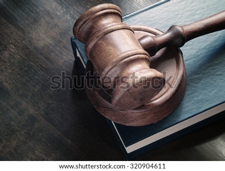Gavel and legal book on wooden table