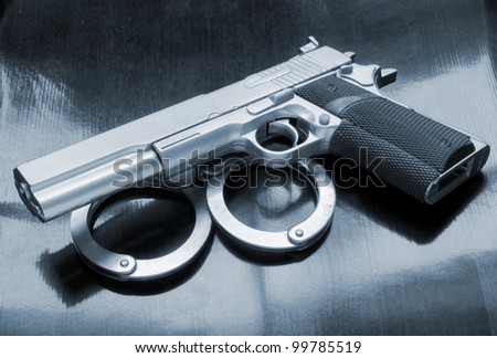 Gun and handcuffs on table