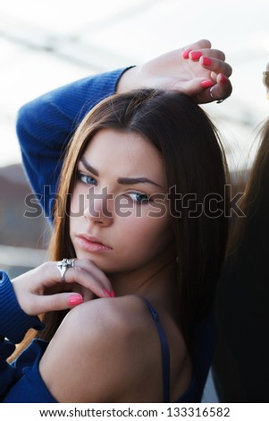 Model posing in a blue blouse