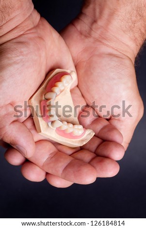 detail dental wax model in human palm