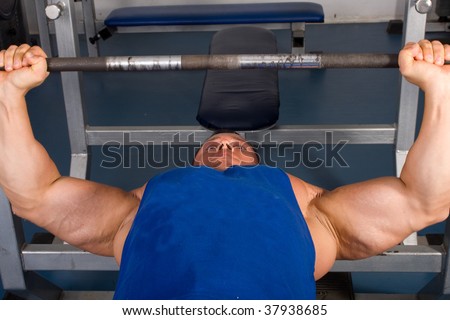 Bodybuilder training in the gym -bench press