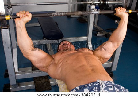 Bodybuilder training in the gym -bench press