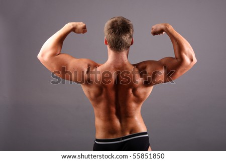 bodybuilder showing his muscles in studio