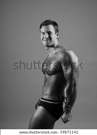 young bodybuilder posing in studio -black and white photo