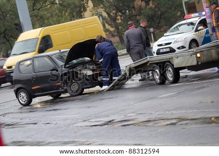 PECS, HUNGARY - OCT. 21: car crashed. Repairman try to help the victim of car accident on Oct 21, 2011 on Road 6 in Pecs, Hungary.