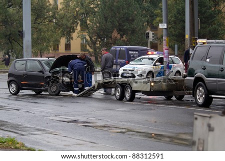 PECS, HUNGARY - OCT. 21: car crashed. Repairman try to help the victim of car accident on Oct 21, 2011 on Road 6 in Pecs, Hungary.