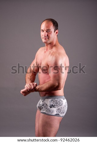 stock photo mature bodybuilder posing in studio