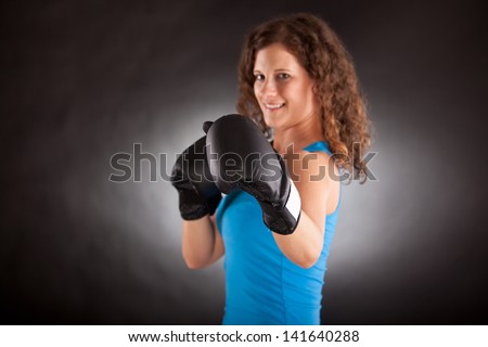 Young beautiful sporty woman with box gloves -focus on glove
