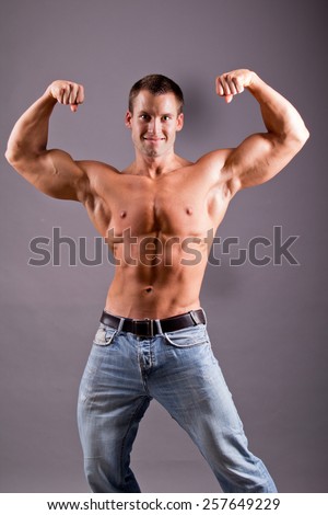 young muscular man flexing his muscles