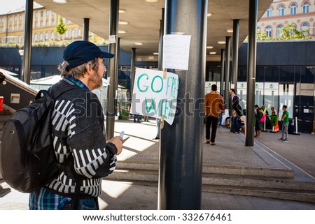 BUDAPEST - SEPTEMBER 7: war refugees reading go Wien text at Keleti Railway Station on 7 September 2015 in Budapest, Hungary. Refugees are arriving constantly to Hungary on the way to Germany.